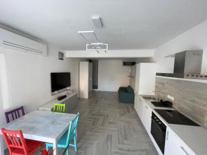 a kitchen with a table and chairs in a room at Holiday House in Ancona