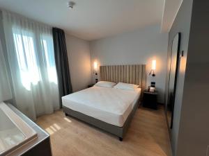 Postel nebo postele na pokoji v ubytování Hotel Leonessa