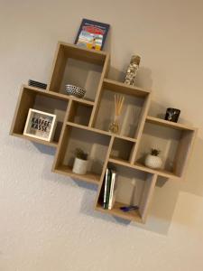 a wooden book shelf on a wall with books at Ferienwohnung Riffgat in Emden