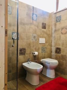 a bathroom with a toilet and a sink and a shower at CASALE PAGI’ in Grottammare +51 photos