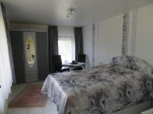 1 dormitorio con 1 cama, mesa y sillas en Sunny Hill, en Oberthal