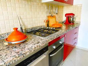 a kitchen with a stove and a counter top at Greeny view in cosy 3BDR - downtown near train / tram in Casablanca