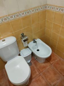 a bathroom with a white toilet and a sink at la hacienda in Islantilla +13 photos
