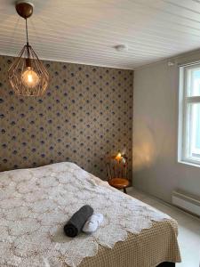 a bedroom with a bed with two stuffed animals on it at In the heart of Old Rauma in Rauma