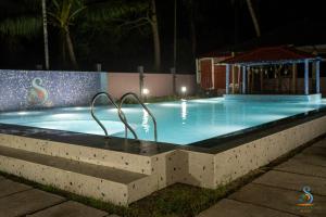 a swimming pool at night with a lighted swimming pool at Senses Havelock resort in Havelock Island