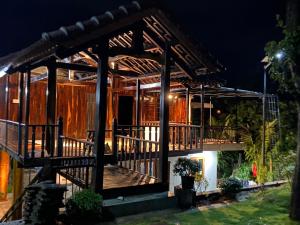 une maison avec une grande terrasse la nuit dans l'établissement Homestay Highland Vân Hòa Phú Yên, à Tuy Hoa