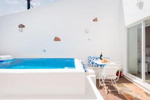 a bedroom with a bed and a swimming pool at Alqueva Rustic Soul in Alqueva