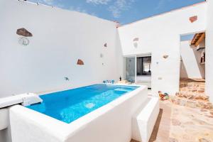 a swimming pool in a white room with a white wall at Alqueva Rustic Soul in Alqueva