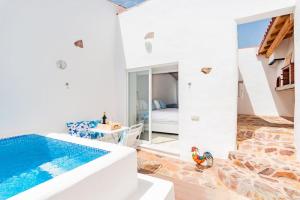a villa with a swimming pool and a bedroom at Alqueva Rustic Soul in Alqueva