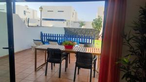 a table and chairs on a patio with a view of a balcony at Villa Lanzarote in Playa Blanca
