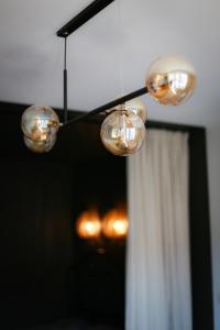 a group of lights hanging from a ceiling at Apartament Cieszynka in Ciechanów +14 photos