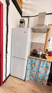 een witte koelkast in een keuken naast een fornuis bij Дом в горах Уютный дом с потрясающим видом и огромной террасой in Besqaynar