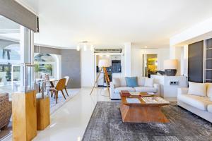 a living room with a couch and a table at The OceanFront Private Residence in La Paz