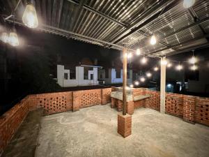 a large room with a brick wall and lights at DoSomething Guest House 5 in Ipoh