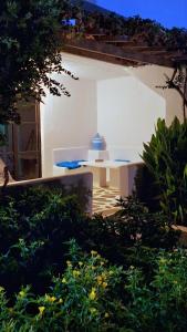 a patio with a table in a building at Chryssa Bungalows in Andros