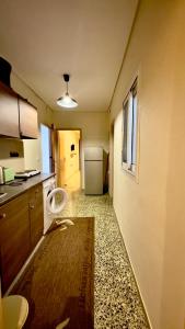 a kitchen with a sink and a refrigerator at Loutraki Suites in Loutraki