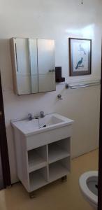 a bathroom with a sink and a mirror and a toilet at Houseboat with aircon and splash pool - 2128 in Kariba