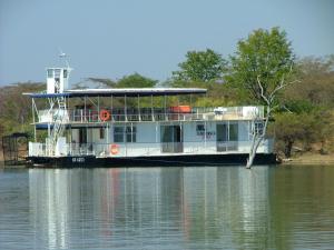 a ferry boat sitting on the water at Houseboat with aircon and splash pool - 2128 in Kariba