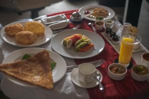 a table topped with plates of breakfast foods and orange juice at Sheraton Grand Bangalore Hotel at Brigade Gateway in Bangalore