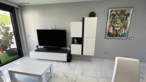 A television and/or entertainment centre at Infinity View ( Arenales del Sol )
