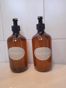 two bottles of soap sitting on top of a counter at Calma in Perdika