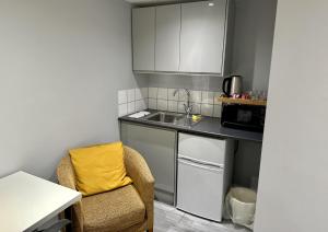 a small kitchen with a sink and a chair at Beautiful 1-Bed Modern Luxury Apartment in Luton in Luton