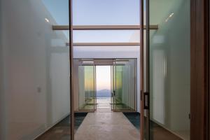 a hallway with a glass door with a view at Pure C in Vathi