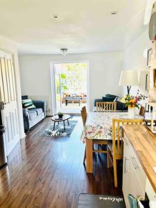 a kitchen and living room with a table and a couch at Ty Lafant in Abergavenny