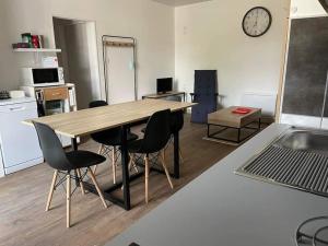 a kitchen with a table and chairs in a room at Chez SamB in Lussac-les-Châteaux