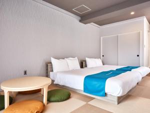 a bedroom with a large bed and a table at Ocean View in Kibogaoka in Onna