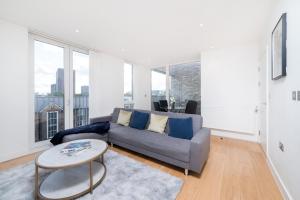 a living room with a couch and a table at Chic London 1 bedroom flat in London