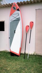 a red and white kayak on the side of a building at Michael’s Vacancies in Fánai