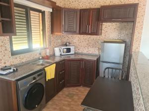 a small kitchen with a sink and a refrigerator at Khalda Rooftop Apt. in Amman