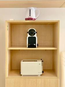 a shelf with a toaster and a appliance on it at Charming Gran Vía V - Largas Estancias in Madrid