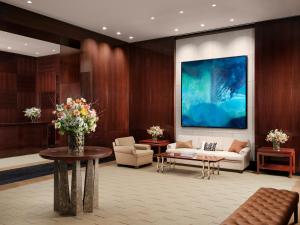 a lobby with a couch and a table with flowers at The Peninsula London in London