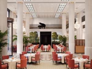 a dining room with tables and chairs and a piano at The Peninsula London in London