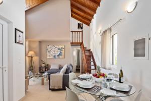 a living room with a table and a couch at Peroulades Luxury Villa in Peroulades