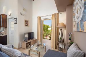 a living room with a couch and a tv at Peroulades Luxury Villa in Peroulades