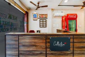 a bar with a coca cola sign on it at Collection O G Silver Near Airport in Chennai