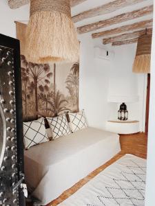 a bedroom with a bed and a wall with a painting at Maison Belhazar in Essaouira