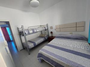 a bedroom with two bunk beds and a window at La Almadraba in Novo Sancti Petri