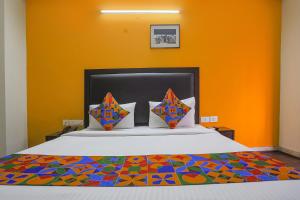 a bedroom with a bed with a colorful bedspread at FabHotel All In One in New Delhi