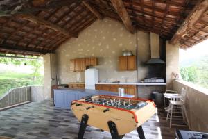 a kitchen with a pool table in the middle of a room at Hameau des Oraisonis in Bras-dʼAsse +21 photos