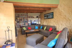 a living room with a couch and a table at Hameau des Oraisonis in Bras-dʼAsse
