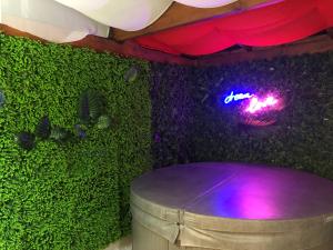 a stage with a barrel and a neon sign at Kings Villa near Disneyland reserved only for family with kids in Saint-Germain-sur-Morin +55 photos
