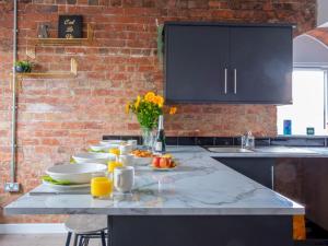 a kitchen with a table with plates of food on it at Pass the Keys Wonderful historic conversion in Doncaster