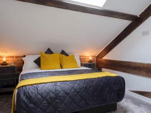 a bedroom with a bed with yellow pillows at Pass the Keys Wonderful historic conversion in Doncaster