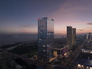 a tall building with lights on in a city at Shantou Marriott Hotel in Shantou