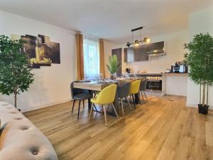 a kitchen and dining room with a table and chairs at Superbe * maison moderne * proche centre * parking privé in Angers