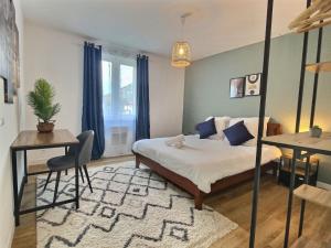 a bedroom with a bed and a table and a desk at Superbe * maison moderne * proche centre * parking privé in Angers